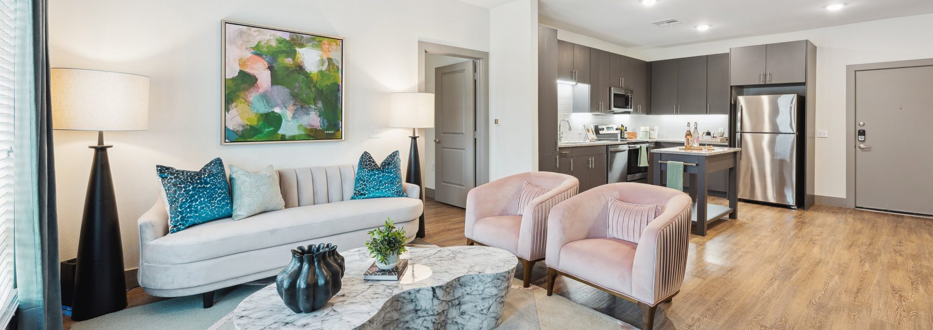 a living room with a couch, coffee table and chairs at The BroadVue